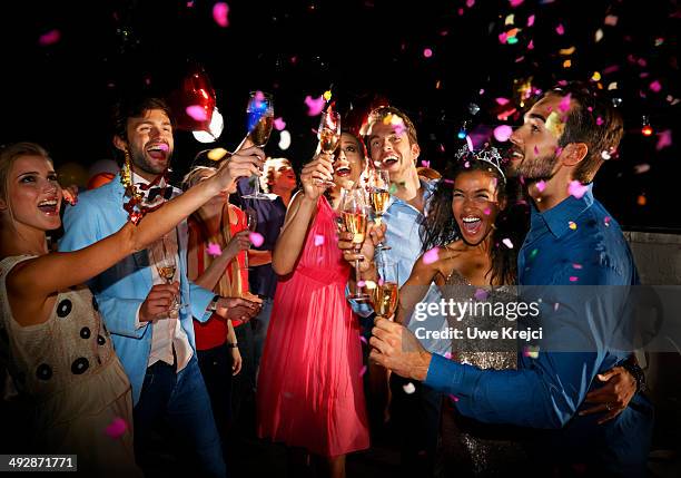 friends celebrating at new year's eve party - new years eve party photos et images de collection