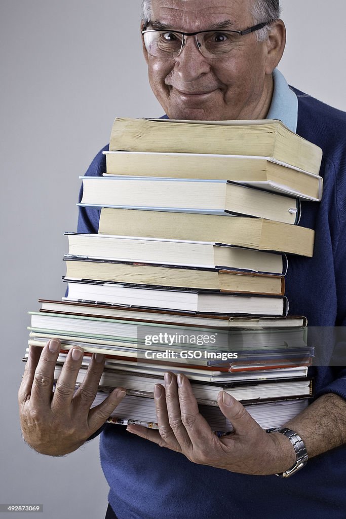 Bookworm holding armful of books