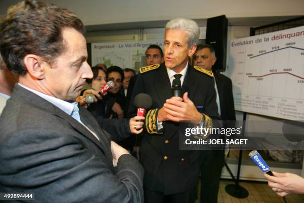 Interior Minister Nicolas Sarkozy listens to a police member during his visit of the "Quartier de la Dalle" in Argenteuil as part of his visit on the...