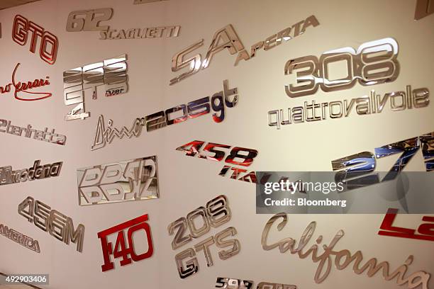 Model names of Ferrari SpA automobiles adorn the wall at the Ferrari museum in Maranello, Italy, on Thursday, Oct. 15, 2015. Fiat Chrysler...