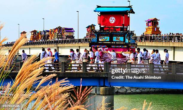 Men march on with floats called 'Danjiri' during the Saijo Festival on October 15, 2015 in Saijo, Ehime, Japan.