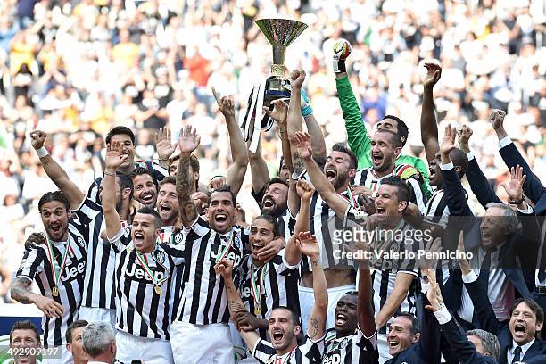 The Juventus FC players celebrate with the Serie A trophy at the end of the Serie A match between Juventus and Cagliari Calcio at Juventus Arena on...