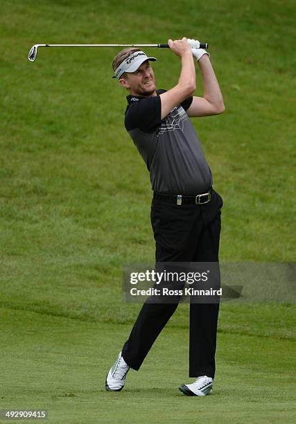 David Lynn of England hits an approach during day one of the BMW PGA Championship at Wentworth on May 22, 2014 in Virginia Water, England.