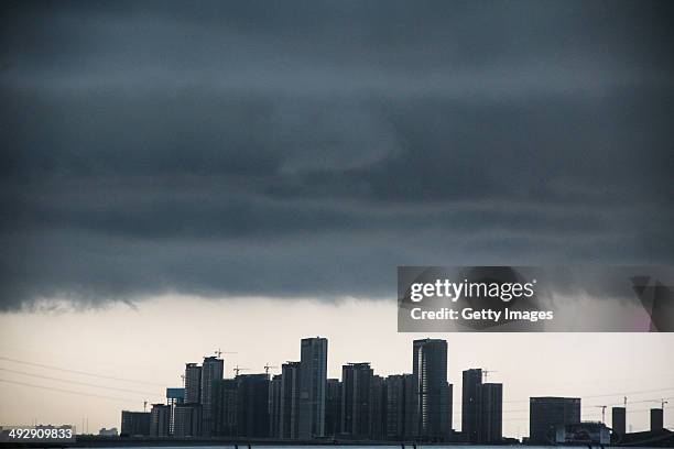 Dark clouds cover the city's skyline on May 22, 2014 in Guangzhou, Guangdong Province of China. Heavy rainstorms expected to batter the southern...