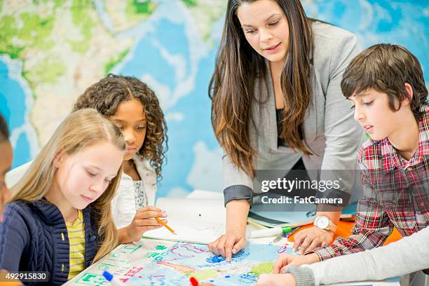 students coloring a map in geography class - history teacher stock pictures, royalty-free photos & images