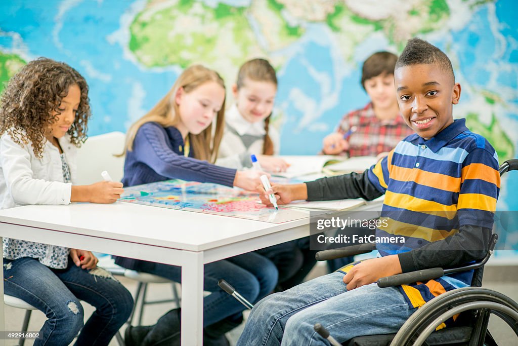 Menino em uma cadeira de rodas na escola primária