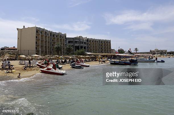 Syrians spend the day at the beach in Latakia, northwest of Damascus, on May 19, 2014. A massive influx of displaced families, mainly from Aleppo, to...