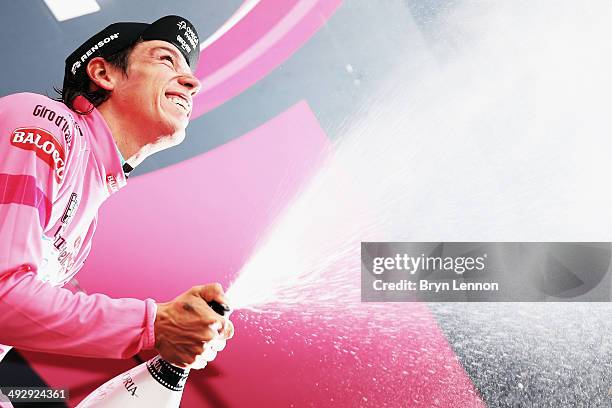 Stage winner and new race leader and wearer of the Maglia Rosa Rigoberto Uran of Colombia and Omega Pharma-Quickstep celebrates and sprays prosecco...