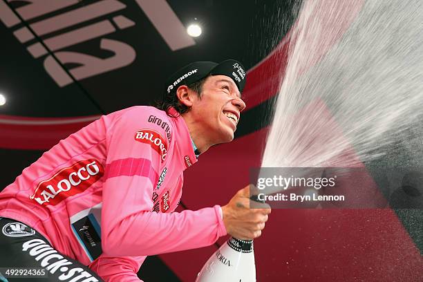 Stage winner and new race leader and wearer of the Maglia Rosa Rigoberto Uran of Colombia and Omega Pharma-Quickstep celebrates and sprays prosecco...