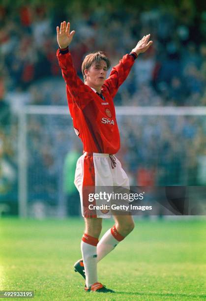 Manchester United player David Beckham celebrates after scoring the third goal with a spectacular effort from the halfway line, during the Premier...