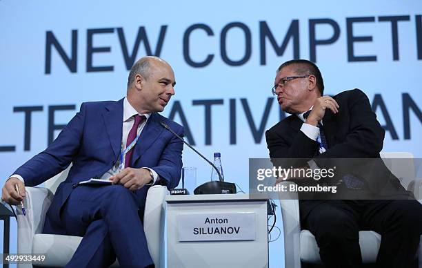 Anton Siluanov, Russia's finance minister, left, speaks to Alexey Ulyukaev, Russia's minister for economic development, during a session at the St....