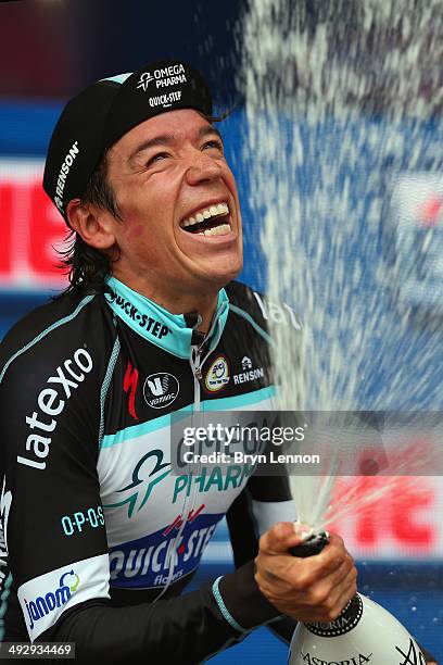 Stage winner and new race leader and wearer of the Maglia Rosa Rigoberto Uran of Colombia and Omega Pharma-Quickstep celebrates on the podium after...