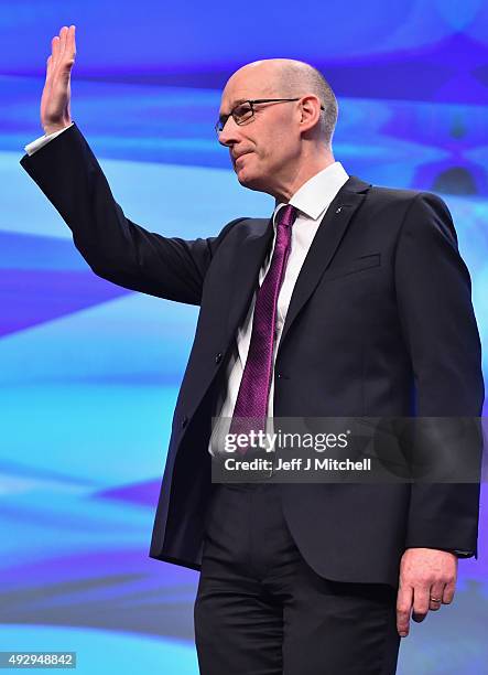 Scotland's Deputy First Minister, John Swinney, is applauded by First Minister Nicola Sturgeon following his speech during the afternoon session on...