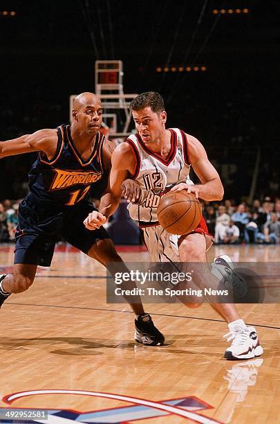 Matt Maloney of the Houston Rockets drives the ball past Bimbo Coles of the Golden State Warriors during the game on November 22, 1997 at the Compaq...