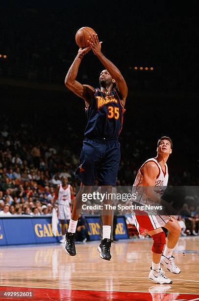 Erick Dampier of the Golden State Warriors shoots over Matt Maloney of the Houston Rockets during the game on November 22, 1997 at the Compaq Center...