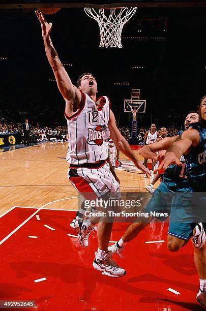 Matt Maloney of the Houston Rockets lays the ball up during the game against the Charlotte Hornets on December 29, 1997 at the Compaq Center in...