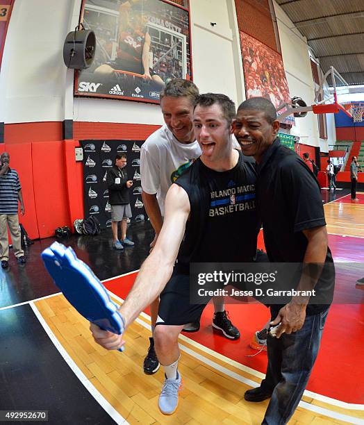 Jason Smith of the Orlando Magic takes a selfie with former NBA players Detlef Schrempf and Muggsy Bogues during practice as part of the 2015 Global...