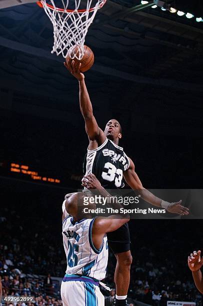 Antonio Daniels of the San Antonio Spurs lays the ball up over Chucky Brown of the Charlotte Hornets during the game on February 24, 2000 at...