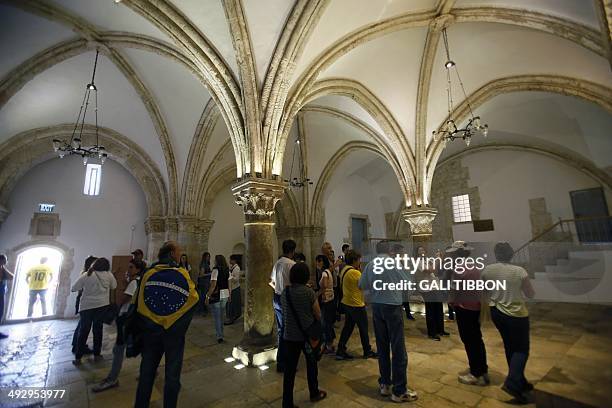 Christian pilgrims from Brazil visit the Cenacle, or Upper Room on Mount Zion just outside the Old City of Jerusalem on May 22, 2014. For Christians,...