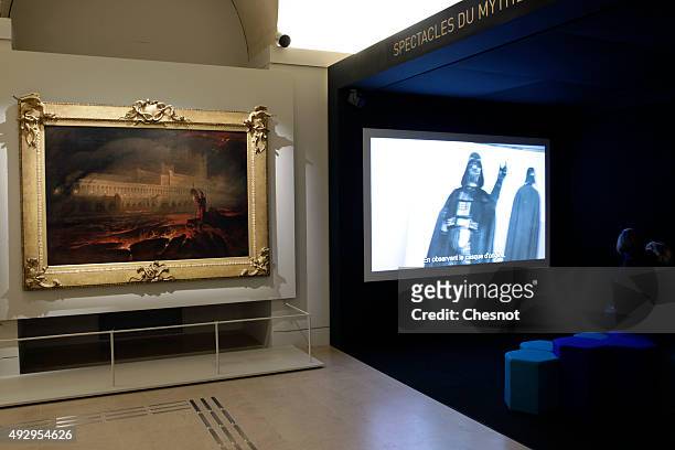 Visitor looks at an extract of the series "Star Wars" during the exhibition "Mythes Fondateurs : D'Hercule a Dark Vador" at Petite Galerie du Louvre...