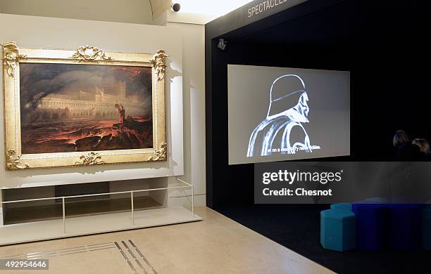 Visitor looks at an extract of the series "Star Wars" during the exhibition "Mythes Fondateurs : D'Hercule a Dark Vador" at Petite Galerie du Louvre...