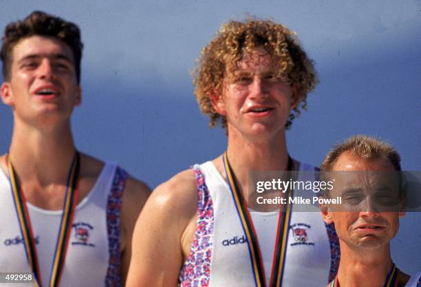 Brothers Greg and Jonny Searle and emotional cox Garry Herbert of Great Britain stand to receive their Gold Medals for the coxed pairs during the...