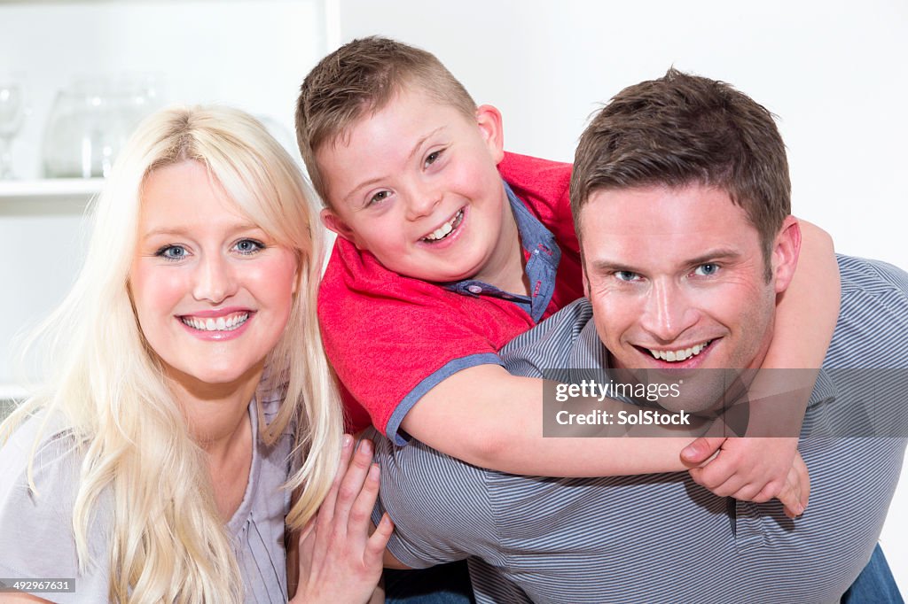 Portrait Of Family With Disabled Son At Home