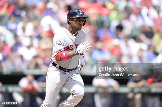 Jonathan Herrera of the Boston Red Sox runs to first base after hitting the ball in the game against the Texas Rangers at Globe Life Park in...