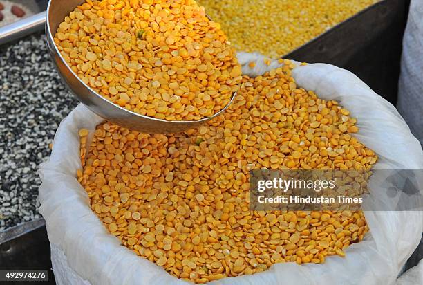 Vendor selling arhar dal pulses at a weekly market on October 16, 2015 in Indore, India. The government today said that it will buy 40,000 tonnes of...