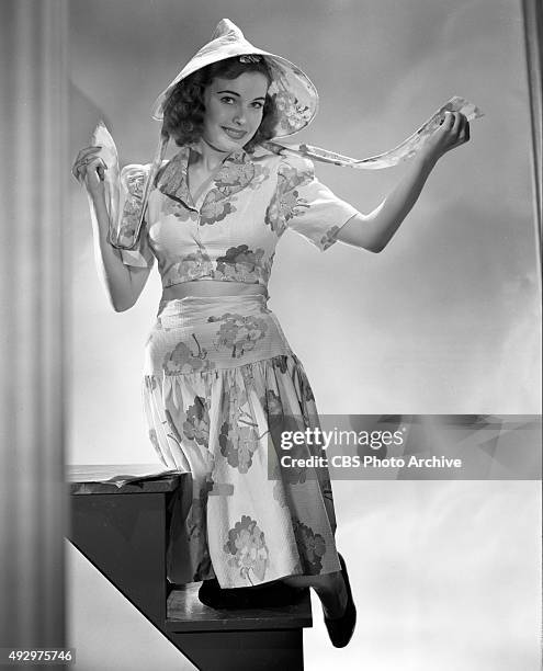 Lois Collier, CBS Radio actress in the Irene Rich serial drama, Dear John. She models some fashionable clothing. Image dated October 18, 1940....