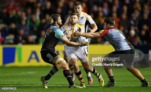 Elliot Daly of Wasps is tackled by the Harlequins defence during the Aviva Premiership match between Harlequins and Wasps at Twickenham Stoop on...