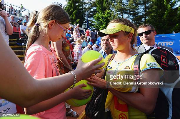 Elina Svitolina of Ukraine signs autographs after winning her match against Mona Barthel of Germany during Day 6 of the Nuernberger Versicherungscup...