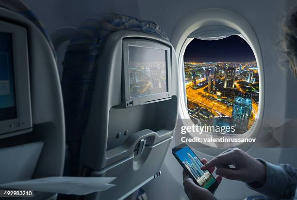 、飛行機から夜の街 - aircraft skyscrapers ストックフォトと画像