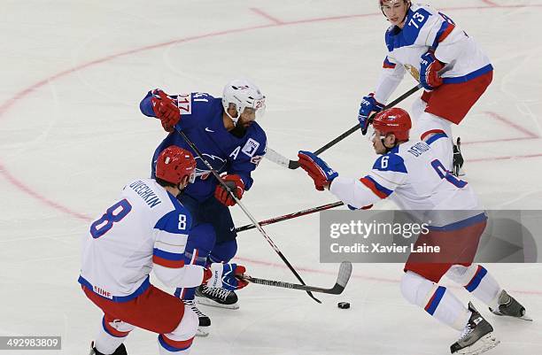 Pierre-Edouard Bellemare of France and Alexander Ovechkin, Denis Denisov and Maxim Chudinov of Russia in action during the 2014 IIHF World...