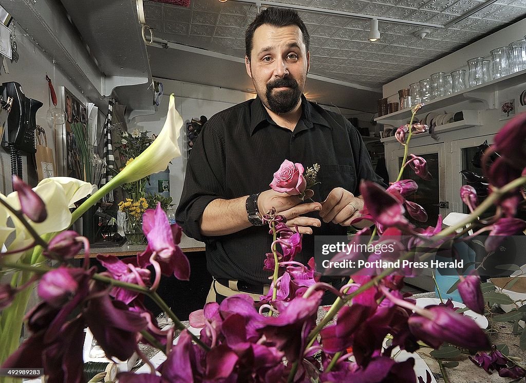 Jason Parent, a floral designer at Harmon's & Barton's flower shop makes up boutonnieres and bouquet