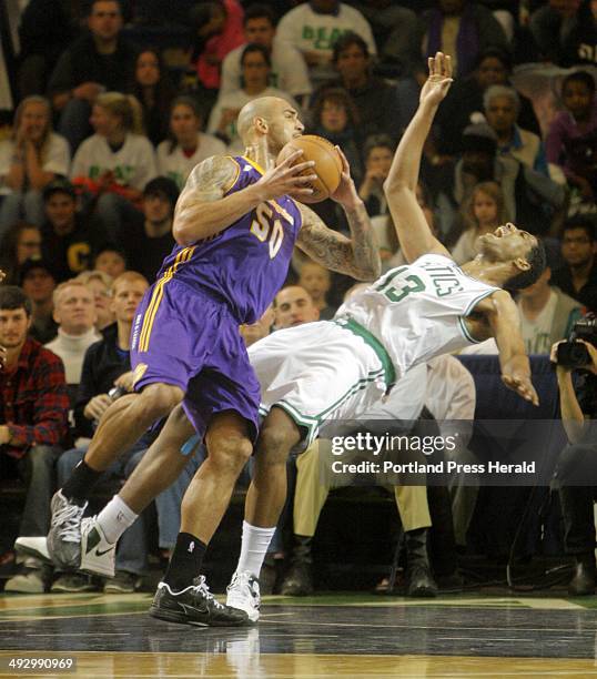 Fab Melo of the Red Claws goes down during a drive by Robert Sacre of the LA D-Fenders during the Red Claws opener in Portland on Friday, November...