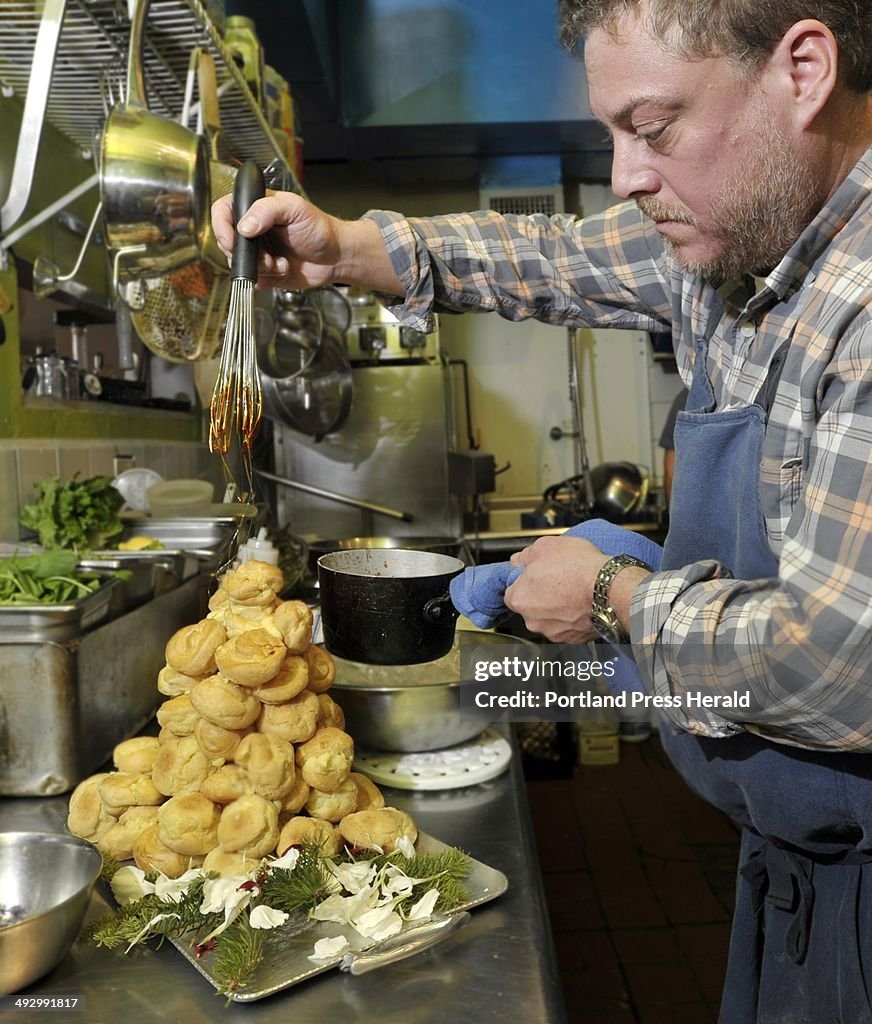 On Wednesday, December 12, 2012, Chef Mitch Gerow drizzles a caramel glaze over the croquembouche he