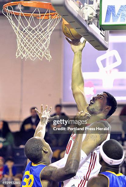 On Friday, January 25 Maine, Fab Melo slips one from behind the basket over Santa Cruz, Mickell Gladness as the Maine Red Claws host the Santa Cruz...