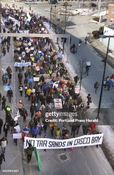 People march to the Maine State Pier in Portland on Saturday, January 26, 2013 to attend a rally protesting the use of the Portland to Montreal...