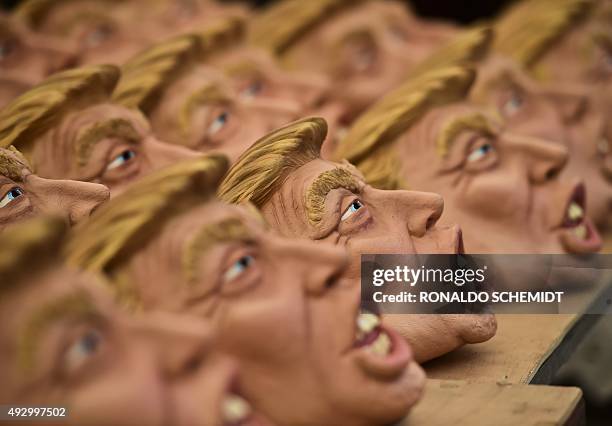 Masks representing US Republican presidential candidate Donald Trump are pictured in a factory of costumes and masks, on October 16 in Jiutepec,...