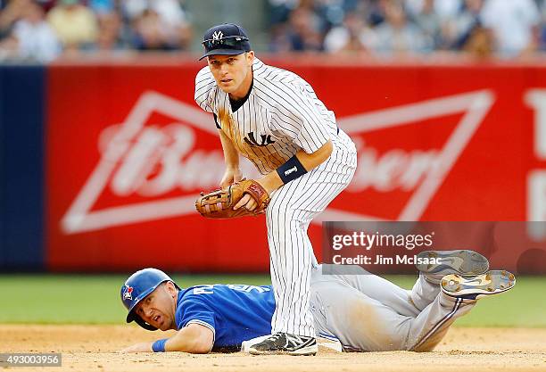 Stephen Drew of the New York Yankees in action against Cliff Pennington of the Toronto Blue Jays at Yankee Stadium on September 12, 2015 in the Bronx...