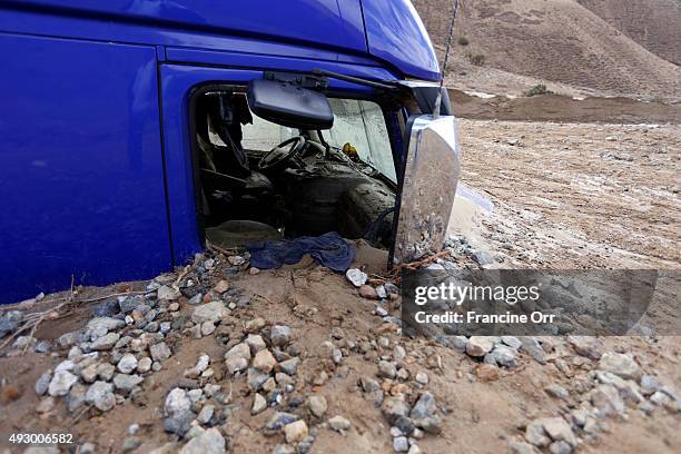 Vehicles affected by the mudslide is seen October 16, 2015 in Telachapi, California. After a heavy rain yesterday, the highway was inundated by...