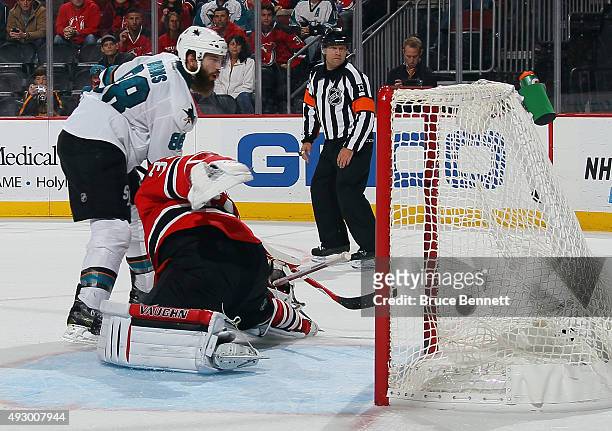 Brent Burns of the San Jose Sharks scores the winner on the shootout against Cory Schneider of the New Jersey Devils at the Prudential Center on...