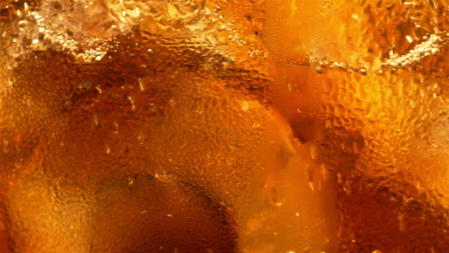 Video of cold cola with ice cubes in 4K