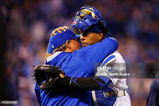 Manager Ned Yost of the Kansas City Royals celebrates with Salvador Perez of the Kansas City Royals after defeating the Toronto Blue Jays 5-0 in game...