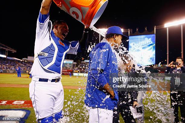 Salvador Perez of the Kansas City Royals douses Edinson Volquez of the Kansas City Royals after defeating the Toronto Blue Jays 5-0 in game one of...