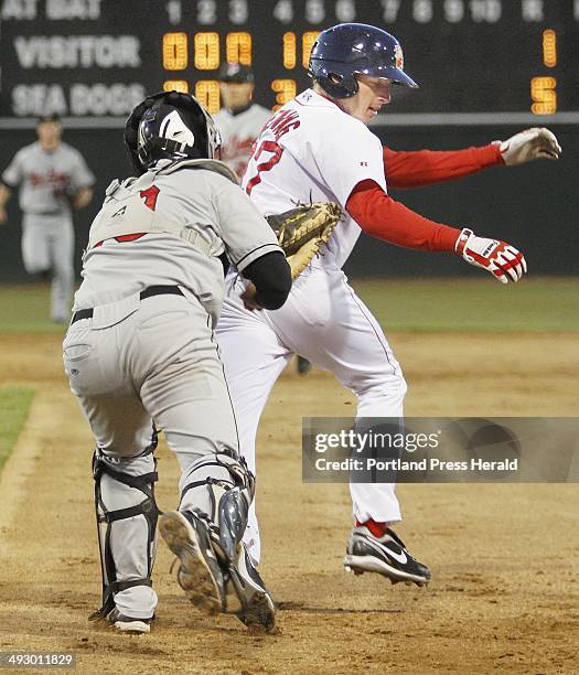 Rock Cats vs Sea Dogs in Portland. Mitch Dening of Portland is tagged out by New Britain's Allan De San Miguel after getting caught in a rundown...