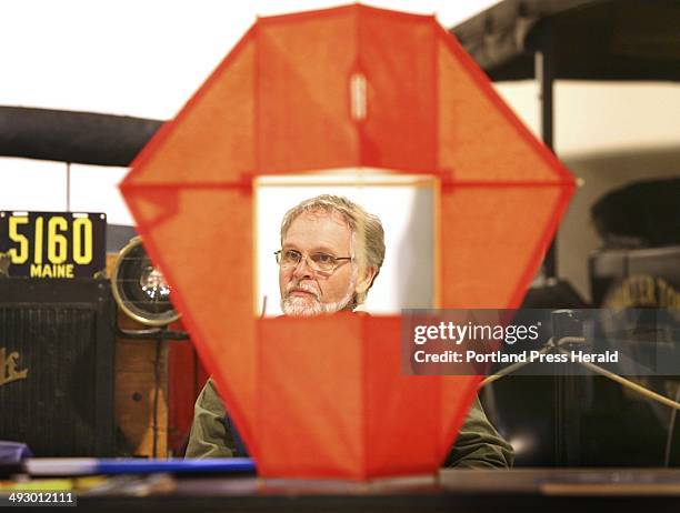 Jay Pendleton of Camden is seen through a box kite built by Robert Betjemann during the Kites, Bikes, and Trikes Family Festival at the Owls Head...