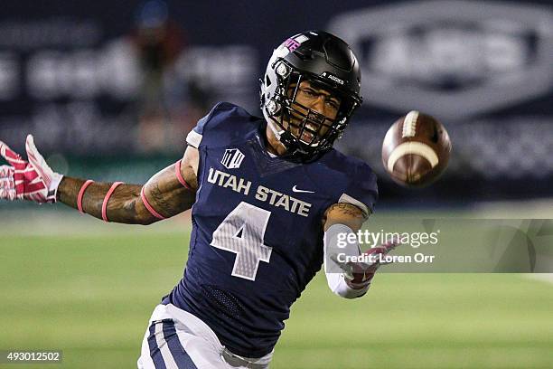 Wide receiver Hunter Sharp of the Utah State Aggies reaches for a long pass during second half action against the Boise State Broncos on October 16,...