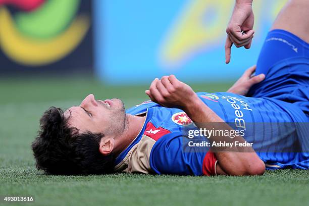 Labinot Haliti of the Jets lays on the ground injured during the round two A-League match between the Newcastle Jets and Sydney FC at Hunter Stadium...